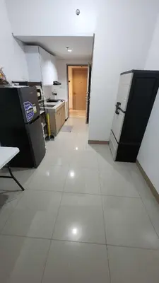 a kitchen with a large white tile floor and appliances at Ivy's CozyStaycation in Dasmariñas