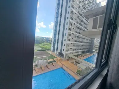 a view of a pool from a window of a building at Ivy's CozyStaycation in Dasmariñas