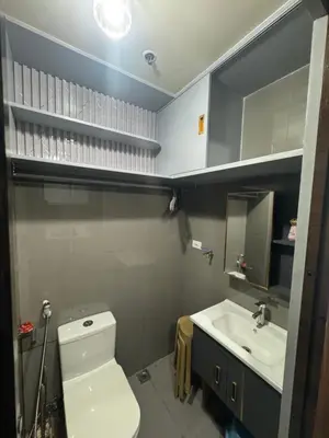a bathroom with a white toilet and a sink at Air Residences MKT in Manila