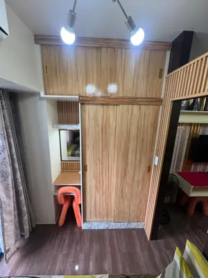 a large wooden door in a room with a table at Air Residences MKT in Manila