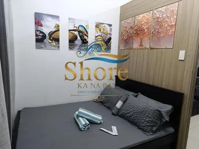 a room with a bed with a phone on it at Amenity Area 2nd floor in Manila