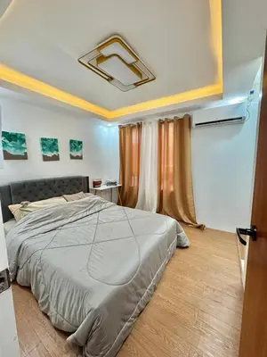 a bedroom with a bed in a room at Sofias Townhouse for Rent in Dasmariñas