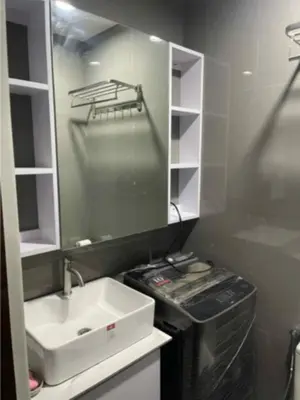 a small bathroom with a sink and a mirror at Maison de Joie' in Manila