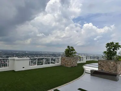 a balcony with a view of a city at The Framehaus with Free Parking at Sonora Garden Residences, Las Pinas in Manila