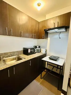 a small kitchen with a sink and a counter at Staycation in Manhattan by House of Mereu in Manila