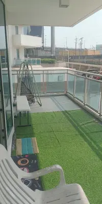a balcony with a swing and a playground on a building at Beach Bliss Your 2 BR Condo Retreat Awaits in Manila