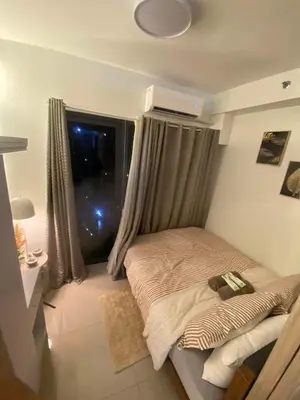 a small bedroom with a bed with a window at H&M staycation Shore 2 tower 2 in Manila
