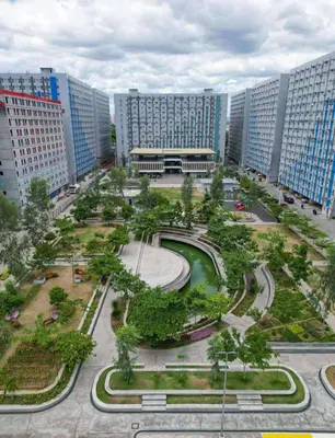 a large city with tall buildings and a park at Coco Home in Manila