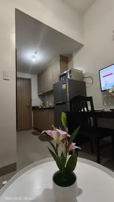 a flower in a pot on a table in a kitchen at Shore Residences Pasay in Manila