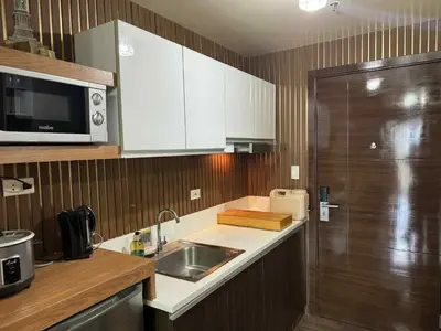 a kitchen with a sink and a microwave at Air Residences 2111k'Pads in Manila
