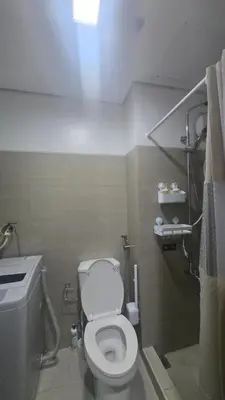 a bathroom with a white toilet and a sink at Book ME at Shore Residences Tower D near Airport & Mall of Asia in Manila