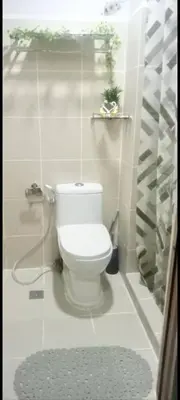 a bathroom with a white toilet in a room at Transient Home Serenity in Manila