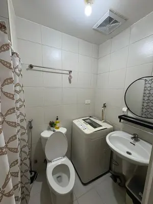 a small bathroom with a toilet and a sink at Condomatch Staycation in Manila