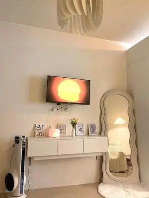 a dressing table with a mirror and a tv at Vie Yśe - Pinterest-style Staycation Near MOA in Manila