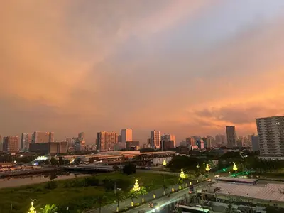 a city skyline at night with buildings and street lights at Althalia Grandsuites Staycation in Manila