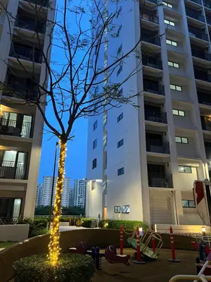 a tree with lights in front of a building at Althalia Grandsuites Staycation in Manila