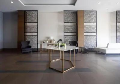 a living room with a table and a couch at Modern 1 BR Condo near Airport, MOA, PICC, Star City, OKADA With Fast WIFI & Netflix Free Pool Access in Sampong