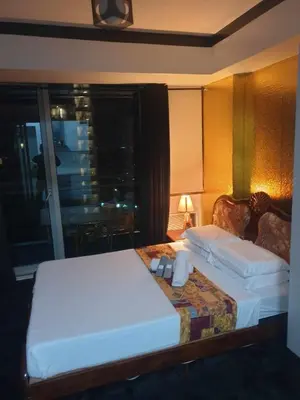 a hotel room with two beds and a window at Azure urban residences bicutan parañaque city in Manila