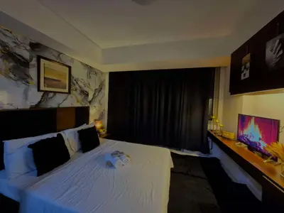 a bedroom with a white bed and a window at Azure urban residences bicutan parañaque city in Manila