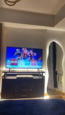 a living room with a large flat screen tv at Azure Urban Resort Residences by JEs Cabin in Manila