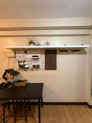 a kitchen with a table and a counter top at Studio Near NAIA Airport in Manila