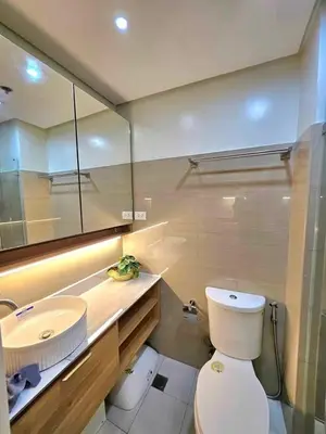 a bathroom with a white toilet and a sink at Mk luxury suite Moa staycation twinbed in Manila