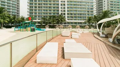 a balcony with white benches and a playground at Miami tower azure staycation in Manila