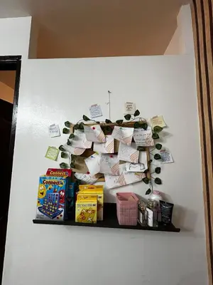 a shelf with a bunch of papers on a wall at Chic Haven Home away from home in Imus