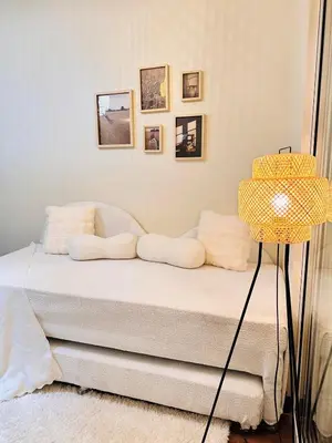 a bedroom with a bed and a yellow lamp at The K-Butter Lounge by Kozy Mood near BGC in Manila