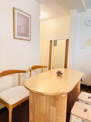 a room with a wooden table and chairs at The K-Butter Lounge by Kozy Mood near BGC in Manila