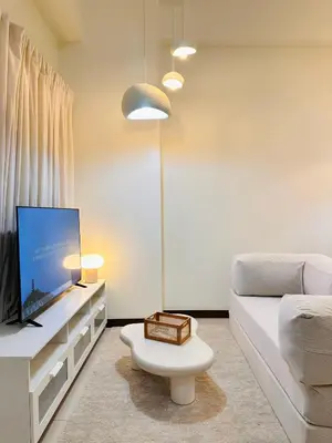 a living room with a couch and a tv at Cloud Cinema by Kozy Mood near BGC in Manila