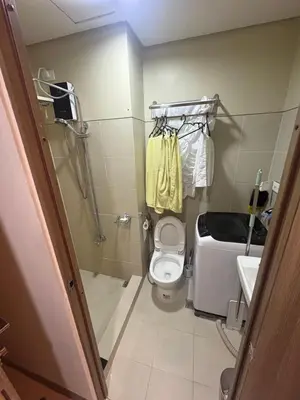a small bathroom with a toilet and a sink at S Residences pool side 3 in Manila