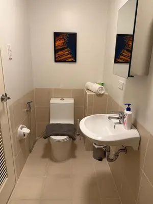 a bathroom with a toilet and a sink at Spacious 3BR Sucat Netflix and Free Parking in Manila