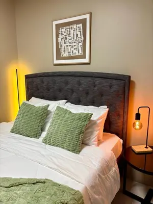 a bedroom with a bed with green pillows at Stylish 1BR Condo in 101 Newport City Near NAIA in Manila