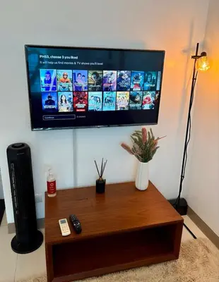 a flat screen tv hanging on a wall at Aesthetic Modern Suite 1BR One Uptown Residence BGC in Manila