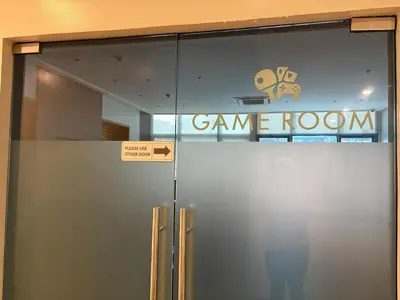 a glass door with a game room sign on it at Aesthetic Modern Suite 1BR One Uptown Residence BGC in Manila