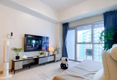 a bedroom with a tv and a large window at 120 Sqm Luxurious 3 bedrooms HighRise Oceanfront,Near Airport,Okada,Solaire Casino,MOA with Free Parking in Manila