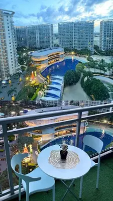 a balcony with a table and chairs and buildings at Condotels Villa Topaz in Manila
