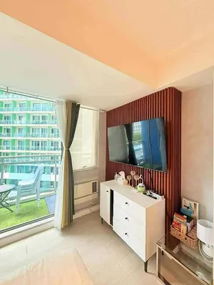 a living room with a tv and a large window at Condotels Villa Topaz in Manila