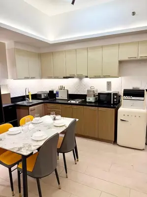 a kitchen with a table and chairs and a kitchen with a table and chairsktop at 29H Ultimate Esports Studio Massage Chair Pro Setup in Manila