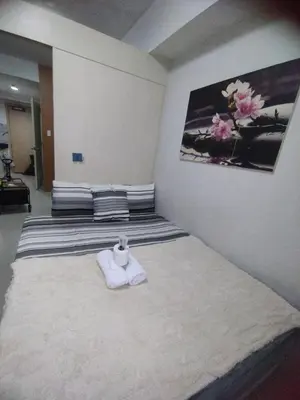 a bedroom with a bed with a towel on it at Sea Residences MOA Area in Pasay City in Manila