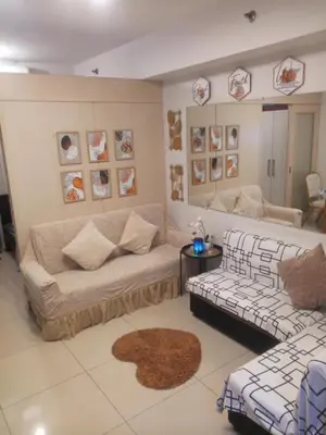 a living room with a couch and two couches at Sea Residences MOA Area in Pasay City in Manila