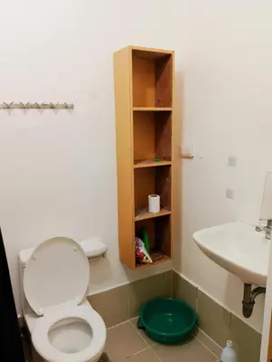 a bathroom with a toilet and a sink at Penguin Hotel in Manila
