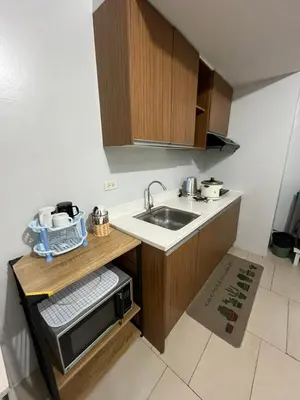 a small kitchen with a sink and a counter at Antel Spa Residences 1710 in Manila