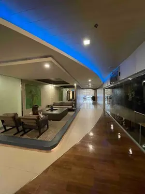 a living room with a couch and a table in a building at Antel Spa Residences 1710 in Manila