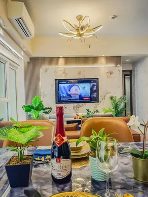 a bottle of wine sitting on top of a table at Spacious & Luxury 4BR Home across Okada and Solaire in Manila