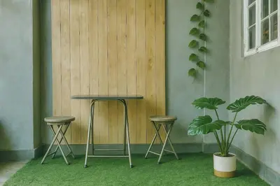 a table and two stools and a plant in a room at Islana Stay for Family of 3 in Gen Trias Cavite in General Trias