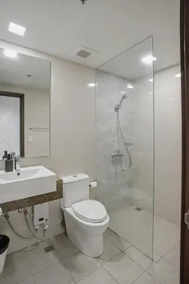a bathroom with a shower and a toilet and a sink at Elegant and Spacious 3BR Home near Okada, Solaire in Manila