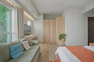 a living room with a couch and a bed at Elegant and Spacious 3BR Home near Okada, Solaire in Manila