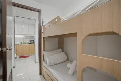 a bunk bed in a small room with a kitchen at Modern and Spacious 3BR Home near Solaire & Okada in Manila
